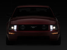 Load image into Gallery viewer, Raxiom 05-09 Ford Mustang w/ Halogen Projector Headlights- Black Housing (Clear Lens) (No GT500 )